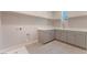 Functional laundry room with cabinets, sink, modern fixtures and plenty of counter space at 128 Los Cabos Dr # 301, Las Vegas, NV 89144