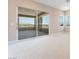 Bright living room with sliding glass doors to patio and views of distant mountains at 128 Los Cabos Dr # 301, Las Vegas, NV 89144