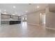 Open floor plan connecting living room and kitchen with modern neutral décor at 128 Los Cabos Dr # 301, Las Vegas, NV 89144