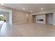 Bright living room with modern fireplace, tile floors, and view to the outside at 128 Los Cabos Dr # 301, Las Vegas, NV 89144