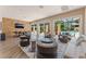 Stylish living room with stone accent wall, modern furniture, and sliding doors to the outdoor pool area at 128 Los Cabos Dr # 301, Las Vegas, NV 89144