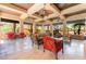 Inviting outdoor lounge area with comfortable seating, ceiling fans, and views of lush greenery at 128 Los Cabos Dr # 301, Las Vegas, NV 89144