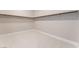 Spacious walk-in closet with neutral carpet and ample shelving for storage at 128 Los Cabos Dr # 301, Las Vegas, NV 89144