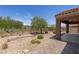 Landscaped backyard with rock, patio, and a view of the golf course at 1407 Wheelwright Ct, Mesquite, NV 89034