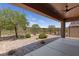Backyard oasis featuring patio, decorative rock, and a manicured green golf course beyond at 1407 Wheelwright Ct, Mesquite, NV 89034
