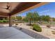 A backyard featuring rock landscaping, a covered patio, and a view of the golf course at 1407 Wheelwright Ct, Mesquite, NV 89034