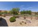 Tranquil backyard space overlooking the golf course, featuring desert landscaping at 1407 Wheelwright Ct, Mesquite, NV 89034