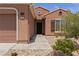 Inviting home exterior with stone accents and a well-manicured front yard at 1407 Wheelwright Ct, Mesquite, NV 89034