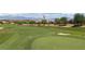 Scenic view of a lush green golf course with mountains in the background at 1407 Wheelwright Ct, Mesquite, NV 89034
