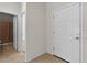 Hallway with white walls, tile floors, and access to the bathroom at 1407 Wheelwright Ct, Mesquite, NV 89034
