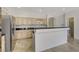 Bright kitchen with stainless steel appliances, tile floors, and breakfast bar at 1408 Reebok Ter, Henderson, NV 89014