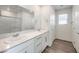 Bathroom featuring double sinks, modern fixtures, a large mirror, and white cabinetry at 1425 Gable Falls Dr # 93, North Las Vegas, NV 89084