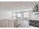Open-concept kitchen and living area with stainless steel dishwasher and gas range at 1425 Gable Falls Dr # 93, North Las Vegas, NV 89084