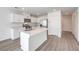 Bright kitchen features white cabinets, stainless steel appliances, quartz countertops, and a center island at 1425 Gable Falls Dr # 93, North Las Vegas, NV 89084