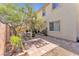 Outdoor space featuring mature shade tree, stone pavers, and partially covered patio at 1476 Evening Song Ave, Henderson, NV 89012