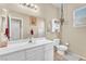 Bathroom with a bright vanity, decorative accessories, and a large mirror at 1476 Evening Song Ave, Henderson, NV 89012