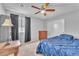 Cozy bedroom featuring carpet, modern ceiling fan and a wooden dresser with ample storage at 1476 Evening Song Ave, Henderson, NV 89012