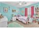 Bright bedroom featuring a ceiling fan, carpet, and a cheerful aqua wall color at 1476 Evening Song Ave, Henderson, NV 89012