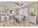 Cozy dining area featuring a ceiling fan, patterned tablecloth, and built-in storage at 1476 Evening Song Ave, Henderson, NV 89012