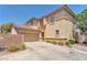 Two-story home showcasing desert landscaping, private driveway, and a two-car attached garage at 1476 Evening Song Ave, Henderson, NV 89012