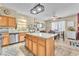 Open kitchen boasting an island with seating, stainless steel appliances, and ample counter space at 1476 Evening Song Ave, Henderson, NV 89012