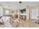 Spacious living room with neutral walls, a piano, and a large flat screen television at 1476 Evening Song Ave, Henderson, NV 89012