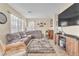 Inviting living room features a comfortable sectional sofa and a large flat-screen television at 1476 Evening Song Ave, Henderson, NV 89012