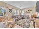 Comfortable living room with tile floors, a cozy area rug, and a large sectional sofa at 1476 Evening Song Ave, Henderson, NV 89012
