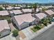 Great aerial view of home with well-maintained lawn, desert landscaping, and two-car garage at 1728 Crystal Chimes Dr, Las Vegas, NV 89106