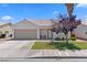Inviting single-story home with well-kept lawn, desert landscaping, and covered entry at 1728 Crystal Chimes Dr, Las Vegas, NV 89106