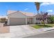 Charming single-story home featuring a desert landscape, two-car garage, and beautiful tile roof at 1728 Crystal Chimes Dr, Las Vegas, NV 89106