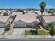 Charming home featuring a well-manicured lawn, desert landscaping, and a two-car garage at 1728 Crystal Chimes Dr, Las Vegas, NV 89106