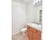 Neat bathroom with oak vanity, a tile countertop, and a large mirror at 1951 Teepee Rd, Pahrump, NV 89048