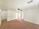 Large bedroom with a ceiling fan, neutral carpet, and doorways leading to adjoining rooms at 1951 Teepee Rd, Pahrump, NV 89048