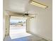 View of the garage showing the open garage door, cement floor, lighting fixture and hardware at 1951 Teepee Rd, Pahrump, NV 89048