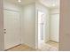 A clean, tiled hallway with access to a water heater closet, storage closet, and the front entrance at 1951 Teepee Rd, Pahrump, NV 89048