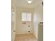 A tidy laundry room with tile flooring, a window, and hookups for a washer and dryer at 1951 Teepee Rd, Pahrump, NV 89048