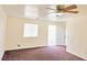 Inviting living room with neutral walls, ceiling fan, window, and doorway to the backyard at 1951 Teepee Rd, Pahrump, NV 89048