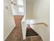 Carpeted staircase leading to a bright, open living area with a ceiling fan and natural light at 1951 Teepee Rd, Pahrump, NV 89048