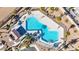 Overhead shot of community pool with unique shape, sunbathing area and lush landscaping at 2225 Chandler Ranch Pl, Laughlin, NV 89029