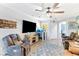 Cozy living room features a large TV, ceiling fan, and comfortable seating area at 2225 Chandler Ranch Pl, Laughlin, NV 89029