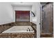 Bathroom with large soaking tub, marble surround, and separate glass shower with marble accents at 2250 Bowie Cir, Henderson, NV 89014