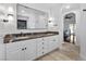 Elegant bathroom featuring dual sinks, marble countertops, white cabinetry, and modern fixtures at 2250 Bowie Cir, Henderson, NV 89014