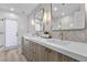 Modern bathroom features double sinks, attractive mirrors and unique light fixtures at 2250 Bowie Cir, Henderson, NV 89014