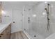Modern bathroom features glass enclosed shower with vertical stacked tile at 2250 Bowie Cir, Henderson, NV 89014
