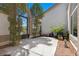 Private courtyard featuring wrought iron gate, mature landscaping, and tiled seating area at 2250 Bowie Cir, Henderson, NV 89014