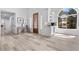Bright foyer with modern bar, hardwood floors, and a custom wood door at 2250 Bowie Cir, Henderson, NV 89014