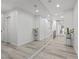Bright hallway features wood-look floors, large mirror and recessed lighting at 2250 Bowie Cir, Henderson, NV 89014
