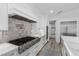 This stunning kitchen boasts stainless steel appliances, a professional range, and stylish white cabinetry at 2250 Bowie Cir, Henderson, NV 89014