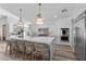 Bright, spacious kitchen features white cabinets, a marble island with seating, and modern stainless steel appliances at 2250 Bowie Cir, Henderson, NV 89014